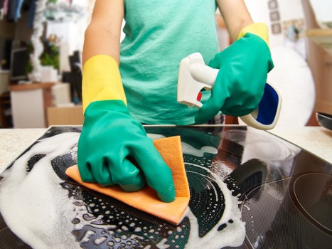 Oven cleaning professional checking kitchen surfaces before starting work