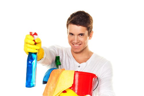 Staff member wearing PPE while cleaning an oven in Balham